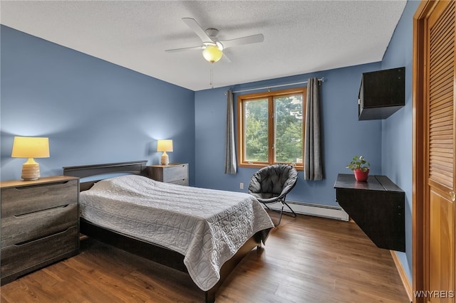 bedroom featuring a baseboard radiator, ceiling fan, a closet, and dark wood-type flooring