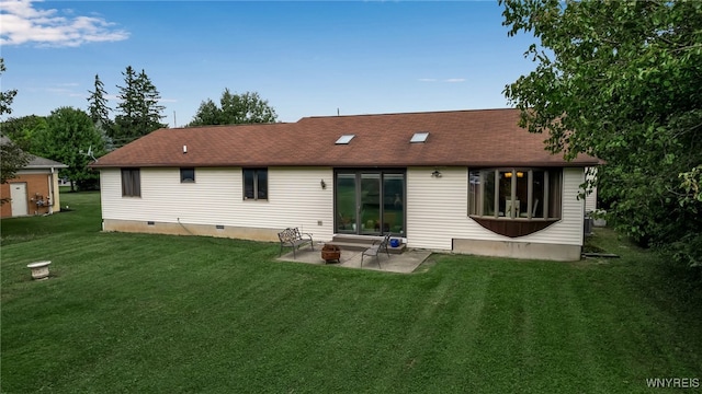 back of property featuring a yard and a patio