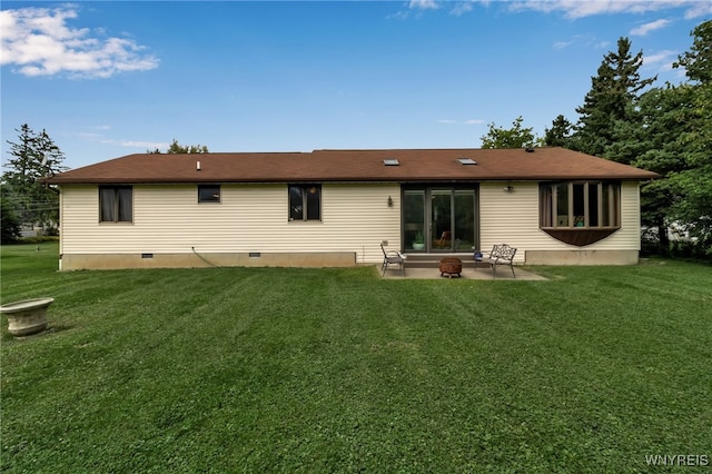 back of property with a patio area and a lawn