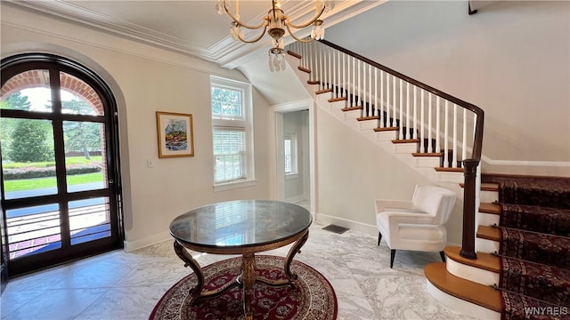 foyer featuring a chandelier and ornamental molding