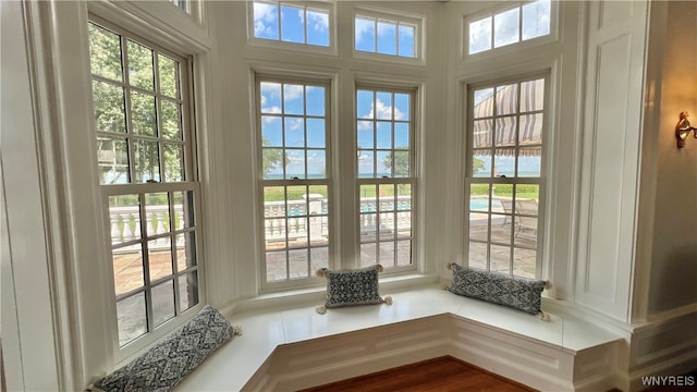 doorway with a water view and a wealth of natural light