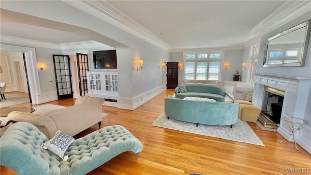 living room with hardwood / wood-style flooring and crown molding