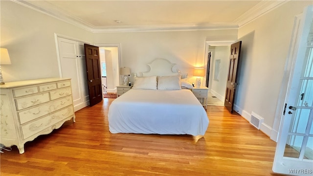 bedroom featuring light hardwood / wood-style floors and ornamental molding