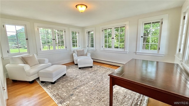 sunroom / solarium with a baseboard heating unit