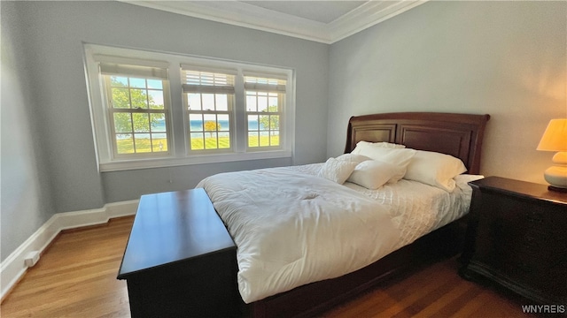 bedroom featuring hardwood / wood-style floors and crown molding