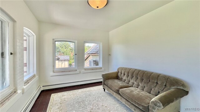 living area with a baseboard heating unit