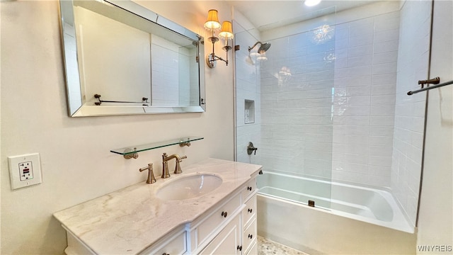 bathroom featuring vanity and tiled shower / bath