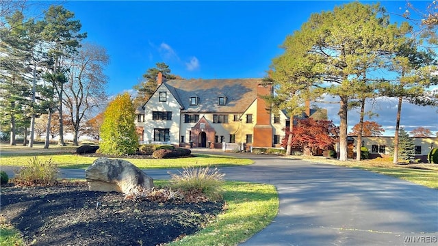 tudor house featuring a front lawn