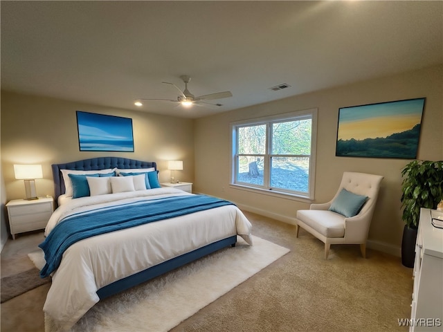 bedroom with ceiling fan and light carpet