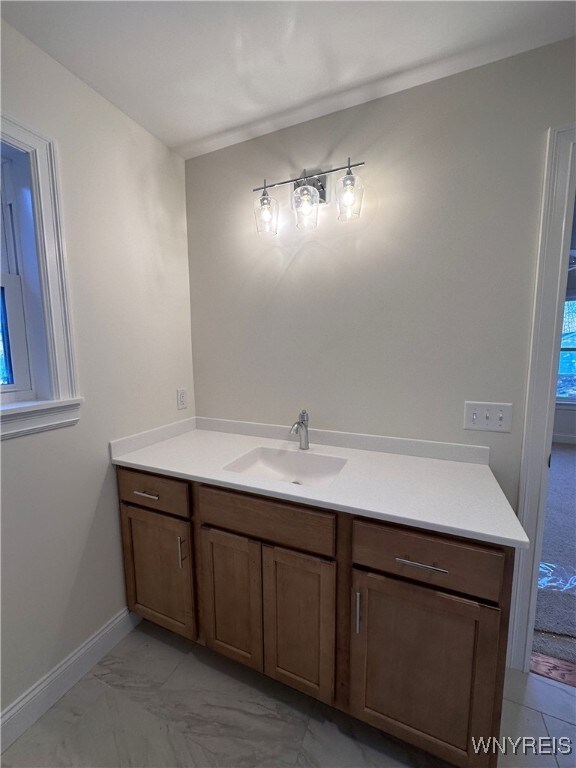 bathroom featuring ornamental molding and vanity