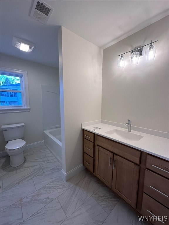 bathroom featuring vanity, a bath, and toilet