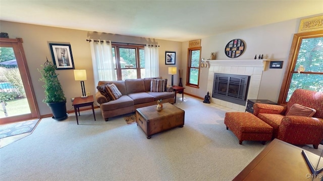 living room with light colored carpet and a tiled fireplace