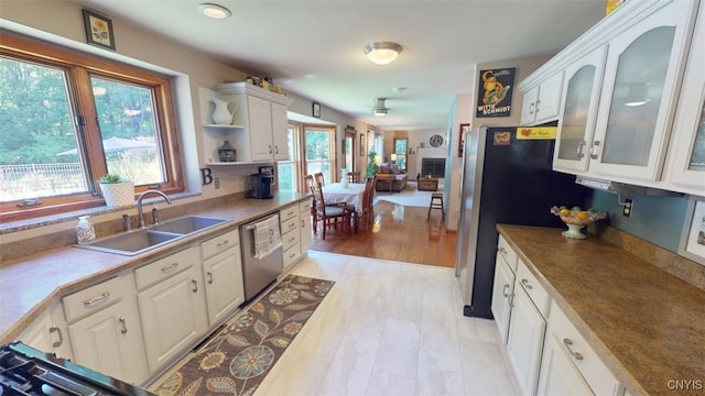 kitchen featuring stainless steel appliances, sink, and white cabinets