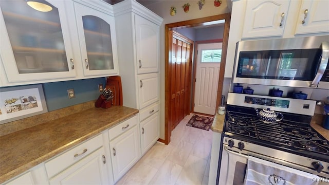 kitchen featuring stainless steel appliances and white cabinets