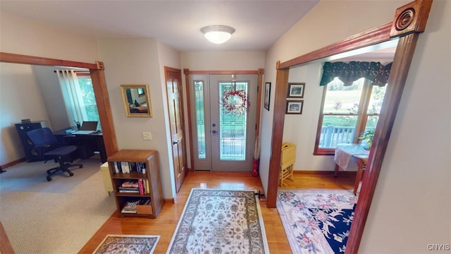 foyer featuring french doors and light hardwood / wood-style floors