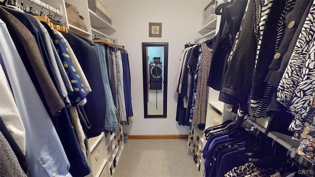 walk in closet featuring light colored carpet