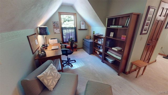 carpeted office space featuring lofted ceiling