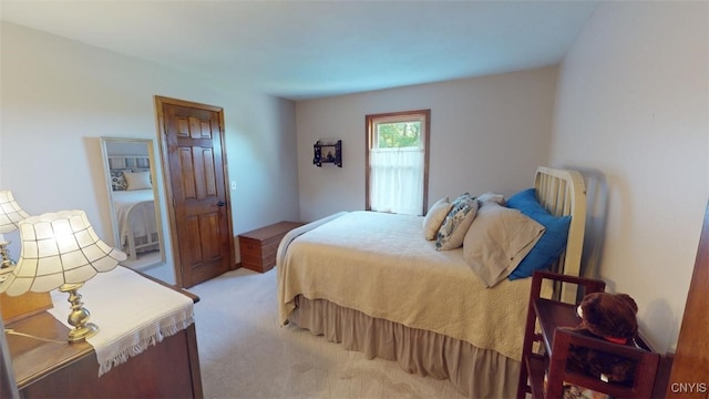 bedroom featuring light carpet