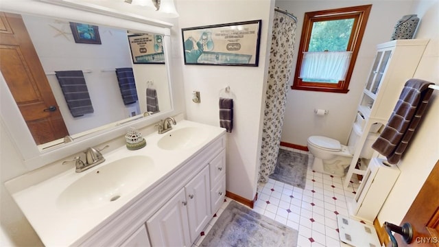 bathroom featuring vanity, tile patterned floors, and toilet