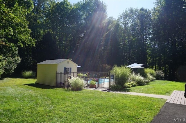 view of yard featuring an outdoor structure and a fenced in pool