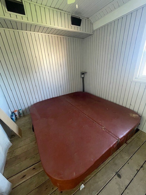 room details featuring wooden walls and wood ceiling