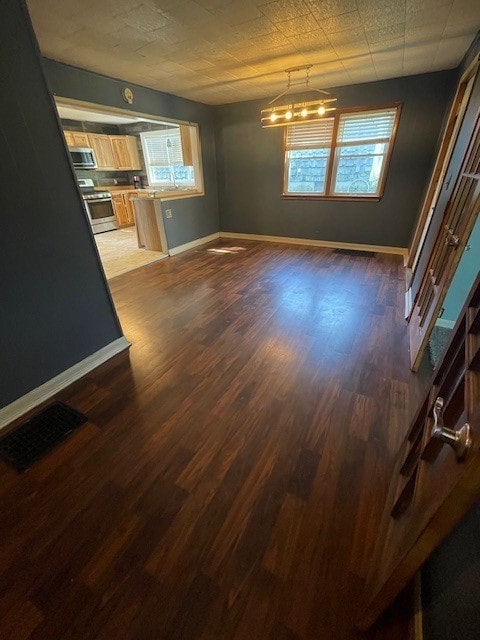 unfurnished living room featuring dark hardwood / wood-style flooring