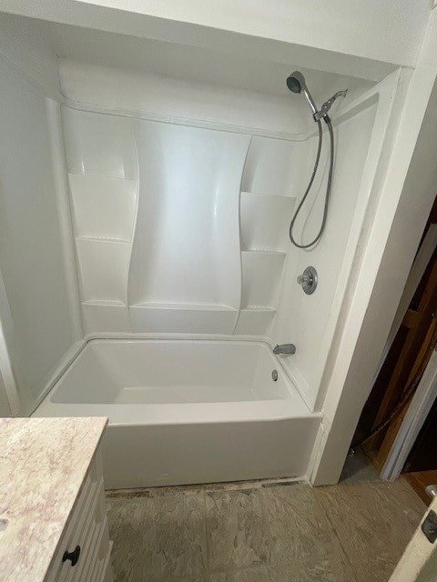 bathroom featuring vanity and  shower combination