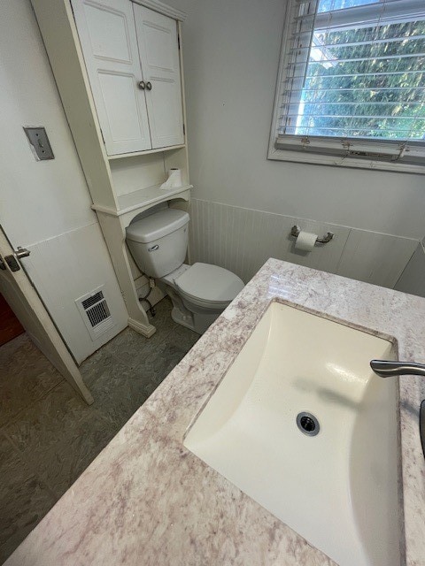 bathroom featuring vanity and toilet