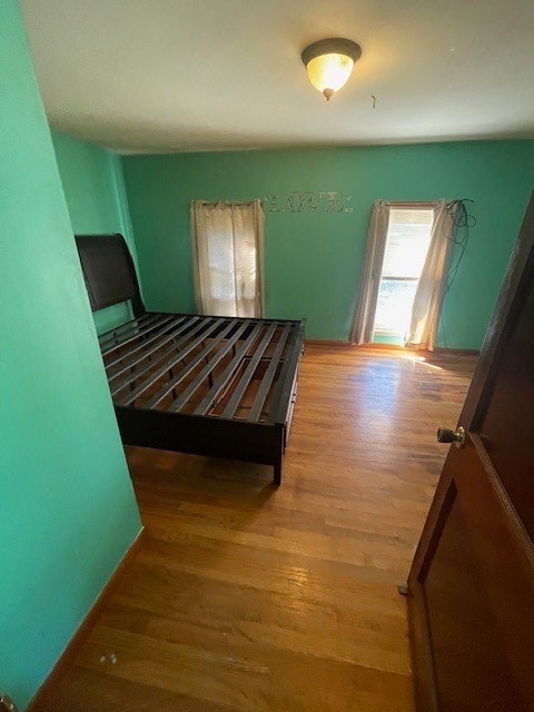 bedroom with wood-type flooring