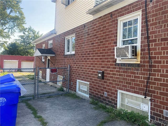 view of property exterior featuring cooling unit, an outbuilding, and a garage