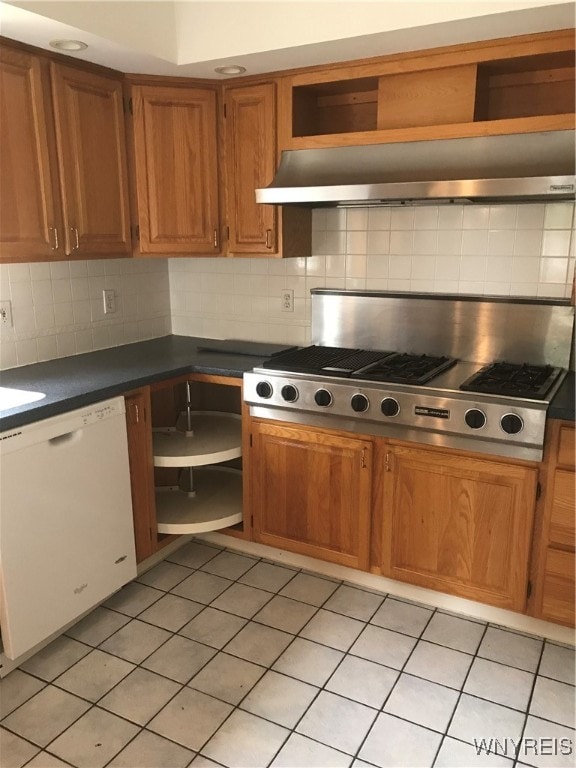 kitchen featuring light tile patterned floors, backsplash, white dishwasher, and stainless steel gas cooktop