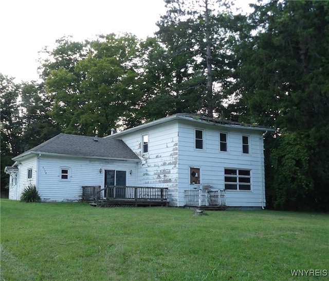 back of house with a yard and a deck