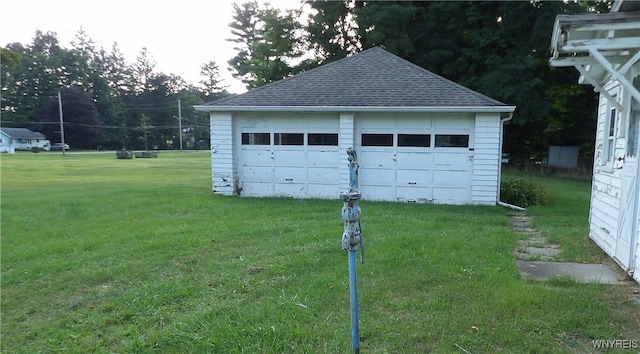 garage featuring a lawn