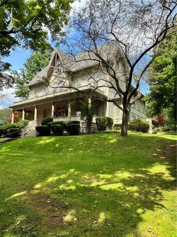 view of side of property with a lawn and a porch