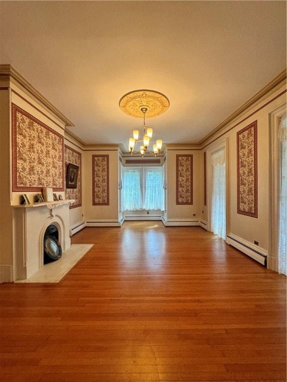 unfurnished living room with a chandelier, hardwood / wood-style flooring, baseboard heating, and crown molding