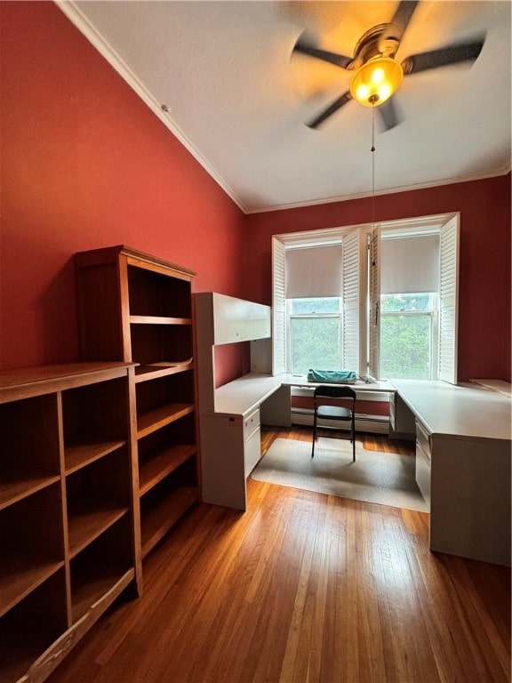 unfurnished office with hardwood / wood-style floors, ceiling fan, baseboard heating, and crown molding