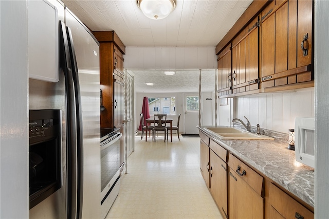 kitchen with sink and stainless steel fridge with ice dispenser