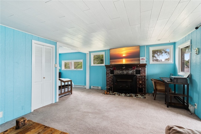 living room featuring a baseboard radiator, wood walls, a brick fireplace, and hardwood / wood-style flooring