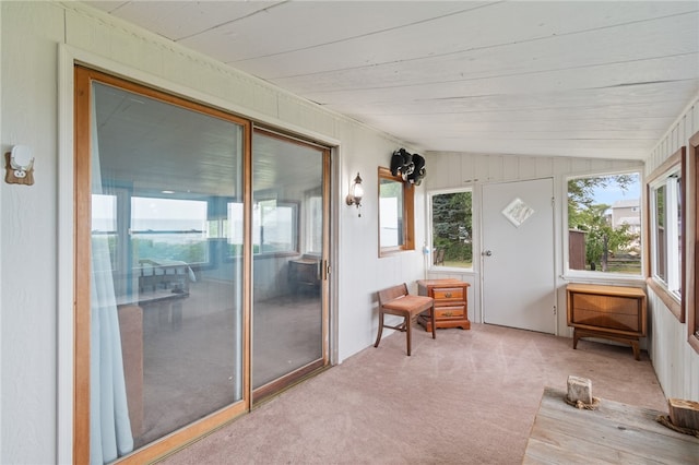 sunroom featuring lofted ceiling and wood ceiling