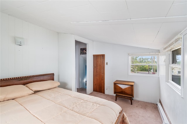 bedroom with lofted ceiling, baseboard heating, and carpet floors