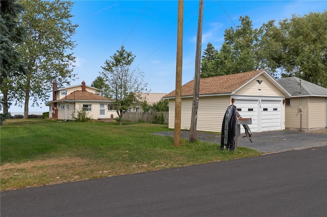 view of front of home with a garage and a front lawn