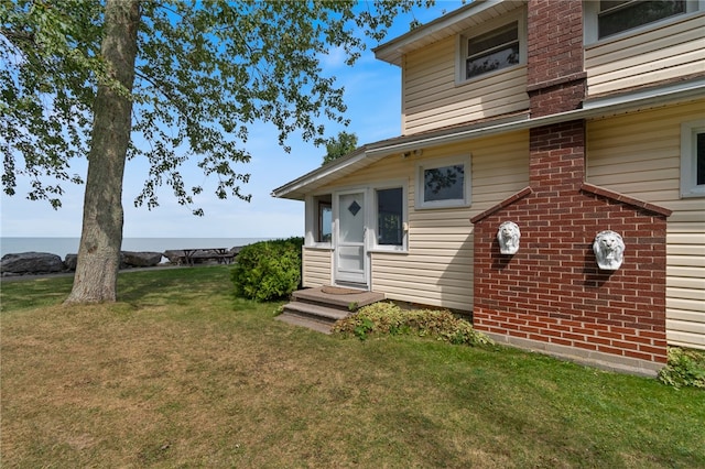 exterior space featuring a water view and a yard