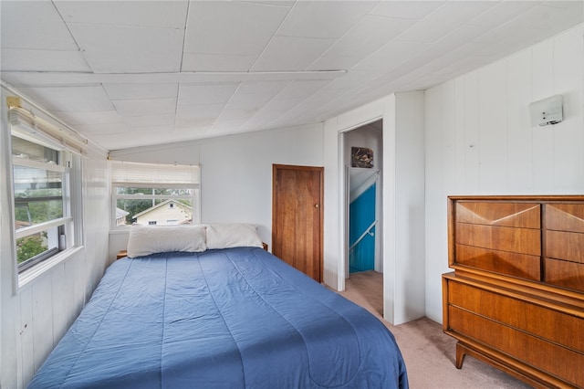 bedroom featuring light carpet and vaulted ceiling