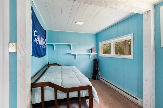 bedroom featuring a baseboard radiator and wooden walls