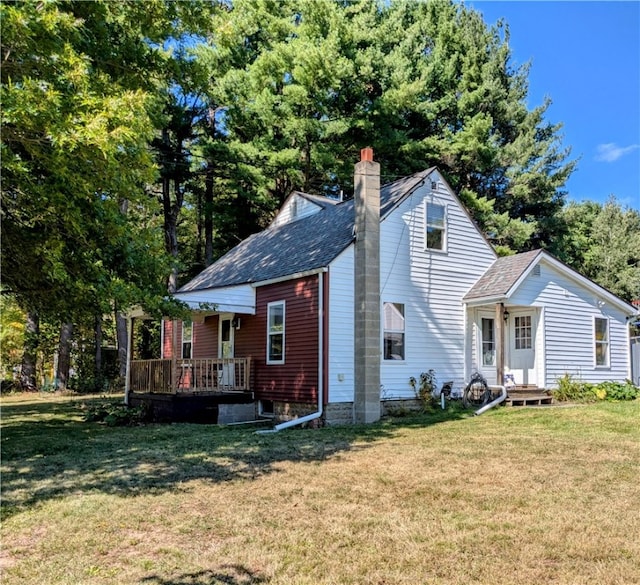 view of front facade with a deck and a front yard