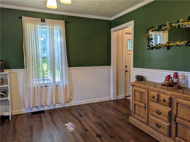 interior space with dark hardwood / wood-style flooring and ornamental molding