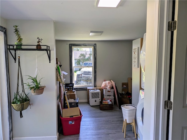 interior space featuring stacked washing maching and dryer