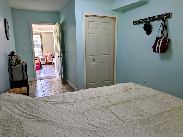 tiled bedroom with a closet