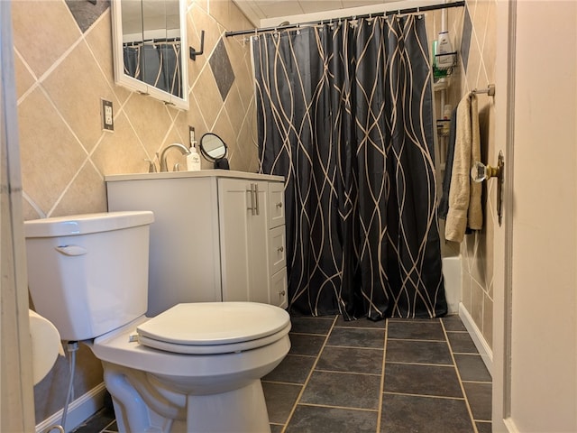 full bathroom with tile walls, toilet, vanity, and tile patterned floors