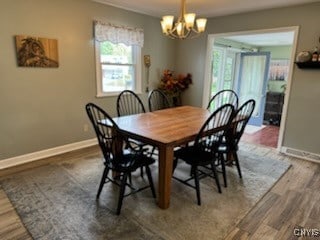 dining area featuring hardwood / wood-style floors and a chandelier